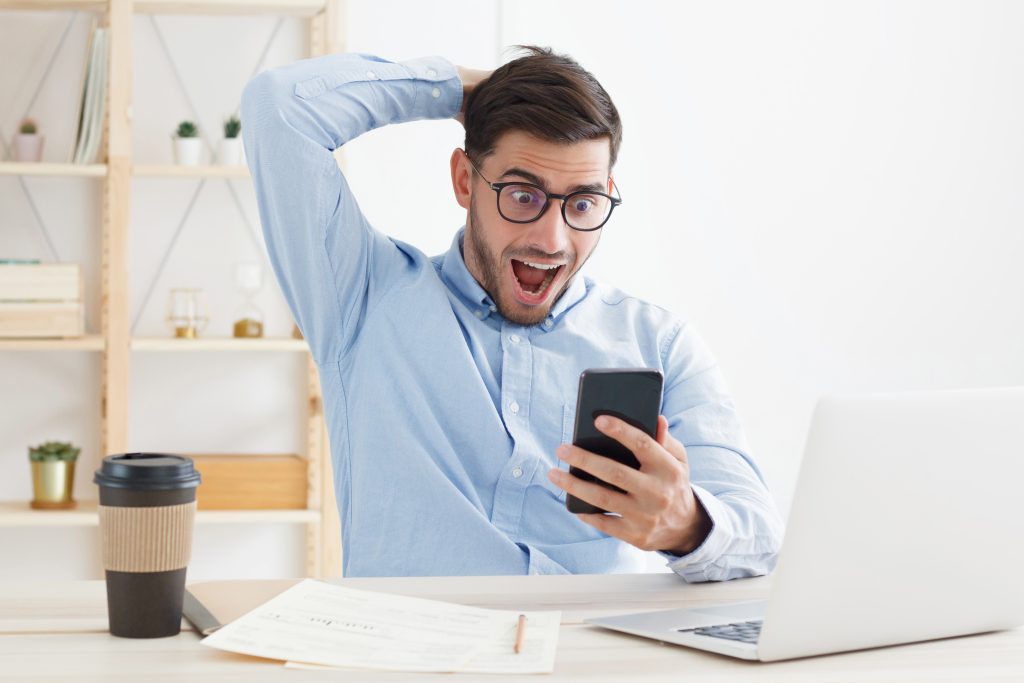 Image of man reaction while looking at Mobile