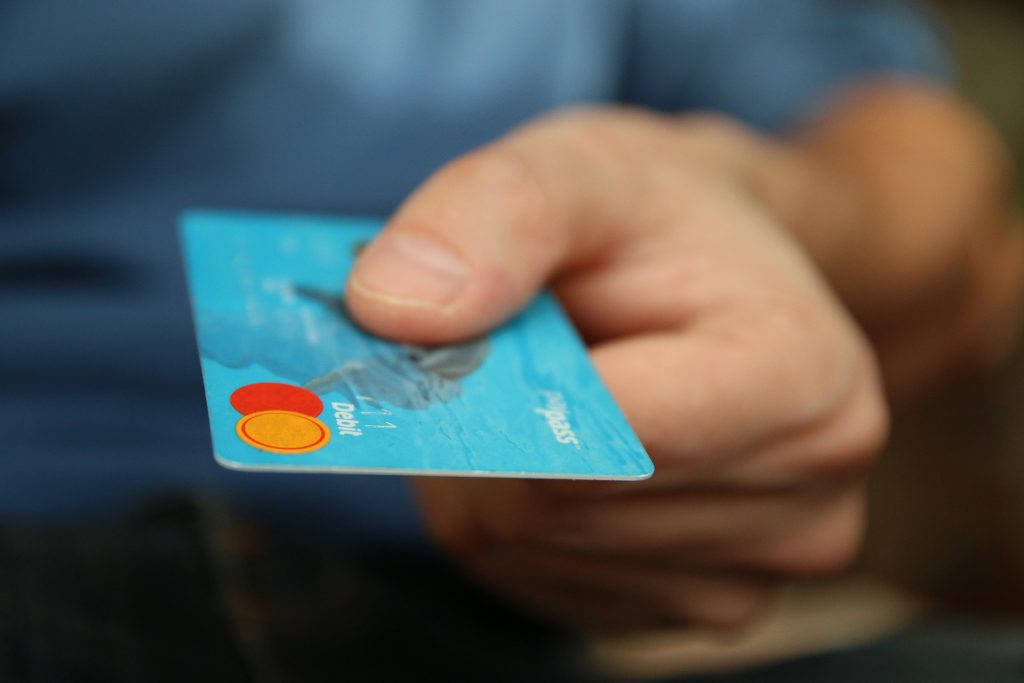Image of person holding debit card